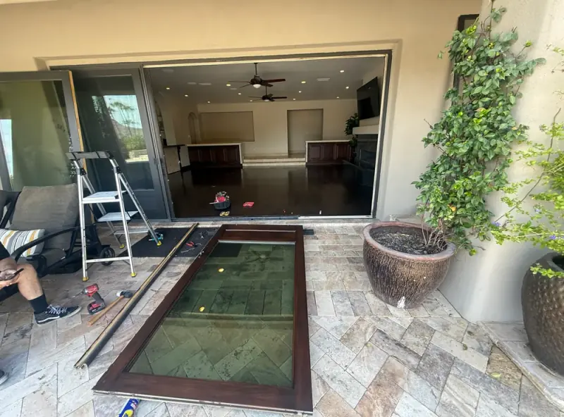 Wide sliding patio door opening with repair tools and a removed door panel