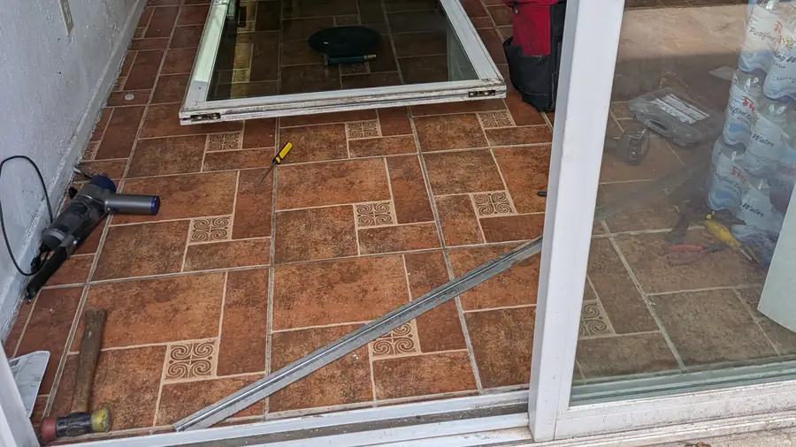 Sliding door panel open at the lower track during repair