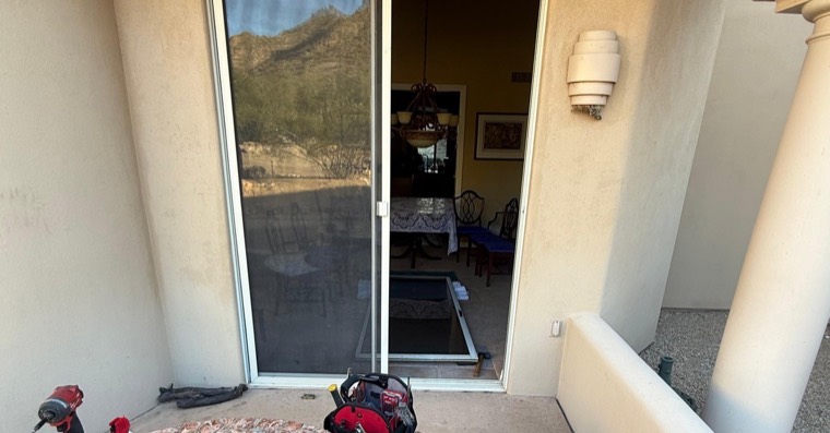 Sliding patio door service setup with tools and door panel