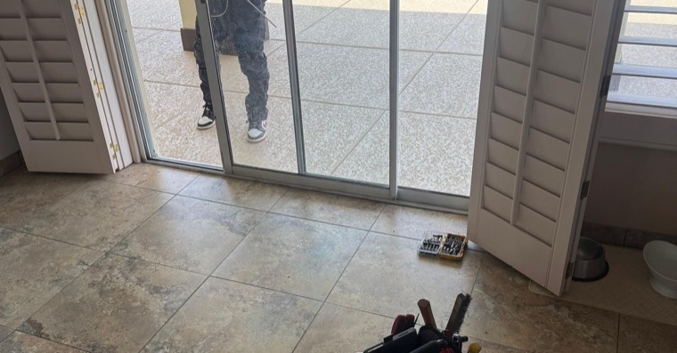 Technician tools near a sliding patio door